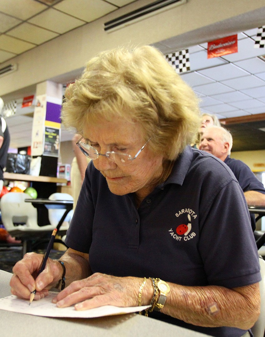 Dee Devlin writes down the scores from the first of three games.
