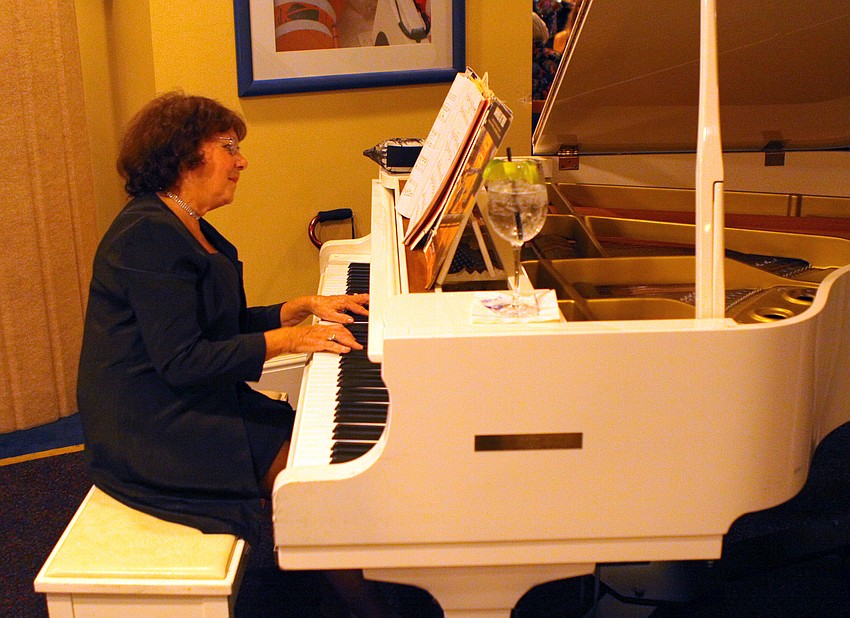 Ann Weber plays the piano during cocktail hour at the Bird Key Yacht Club Commodore's Ball.