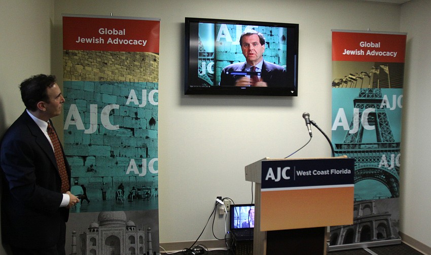 Brian Levin plays a video from the Executive Director of AJC, David Harris, during the ceremonial potion of the AJCâ€™s Grand Opening Cocktail Party.