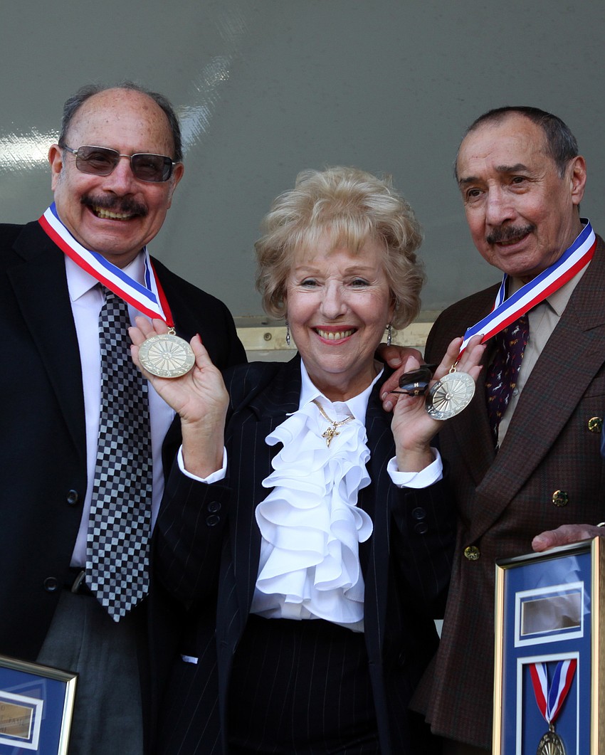 Aurelia Canestrelli Nock stands between Andres and Alberto Atayde. Nock was the sponsor for the Three Atayde Brothersâ€™ induction into the Circus Ring of Fame.