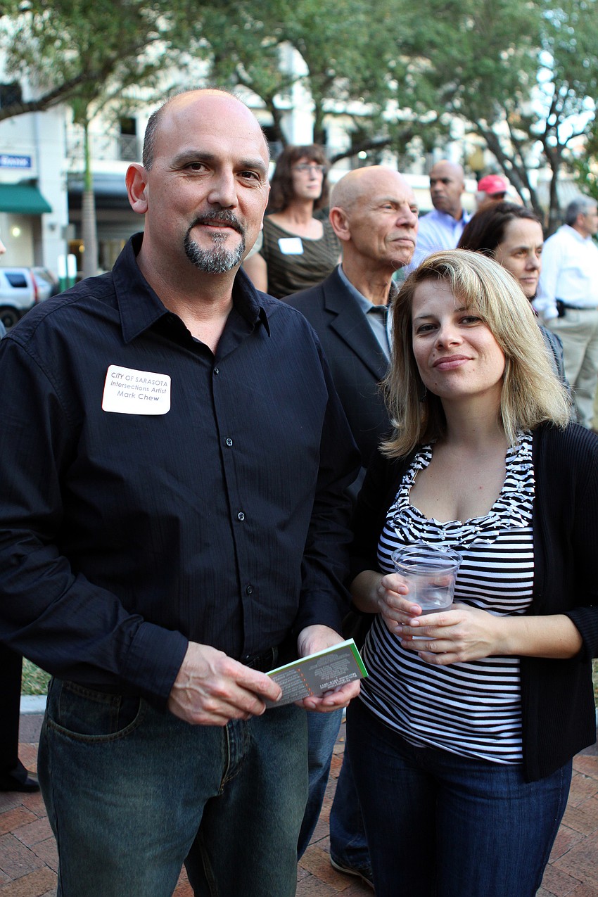 Sculptor Mark Chew and Dr. Anna Koufakou pose together during the Intersections Kickoff Celebration on Thursday, Jan. 20. Chewâ€™s sculpture is called â€œVertigoâ€ and can be seen at the corner of Laurel Street and Orange Avenue.