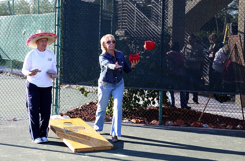Cathy Powell and Kim Lawrence play some cornhole out on one of the tennis courts on Friday, Jan. 28 during Longboat Key Public Tennis Center's Chili Cook-off competition.