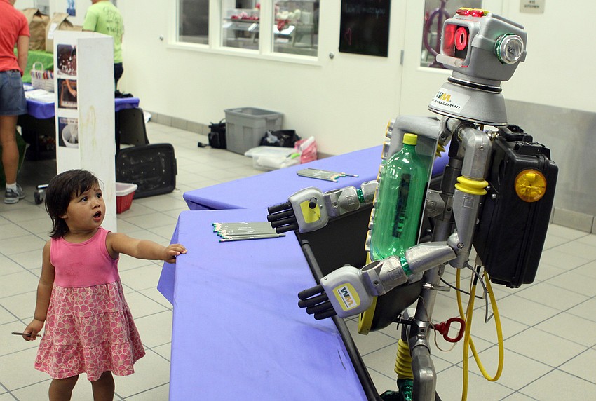 Anandi Fuller, two-and-a-half, looks shocked when Waste Management's robot, Cycler, came towards her on Friday, Feb. 25 at Southside Elementary's Science Night.