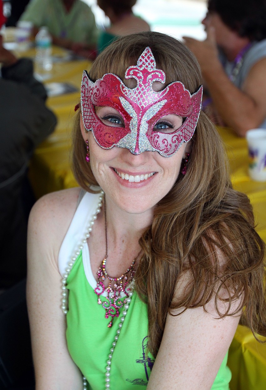 Colleen O'Donnell wears a mask she got two years ago at Carnivale in Veince, Italy.