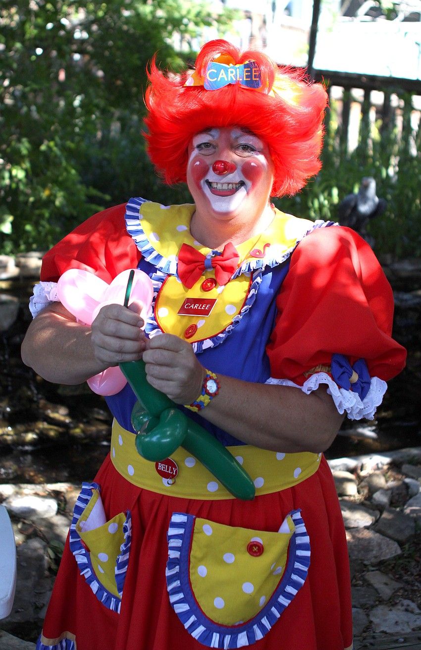 Carlee the Clown makes a balloon flower during the Save Our Seabirds birthday party.