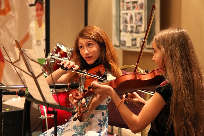 Kayley Holton and Cassidy Gage, 11, perform a violin duet on Feb. 26 at Temple Sinai's 2nd Annual 