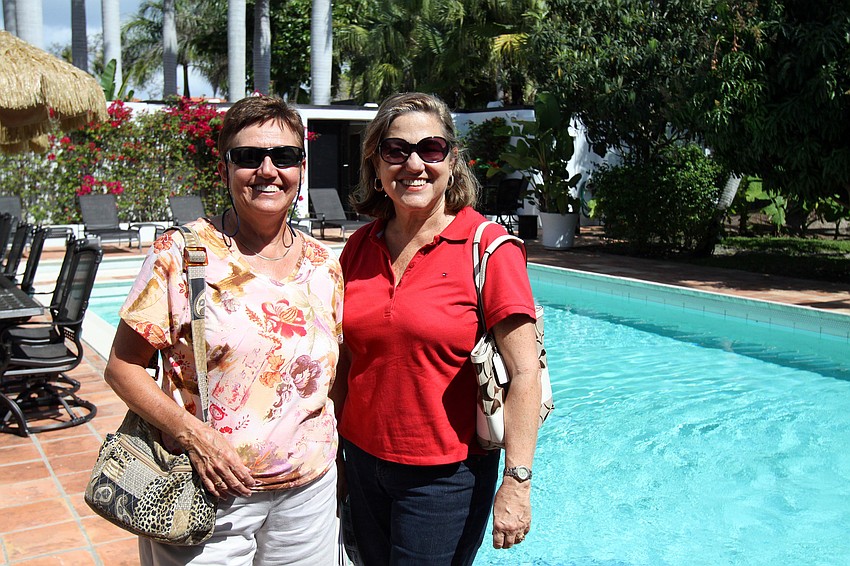 Maria August and Diane Ahntholz pose out by the pool on Saturday, March 5 at the Trine home, one of the homes on the Home and Garden Tour.