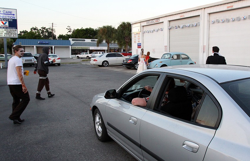 A car full of little girls and their mother watch the zombies.