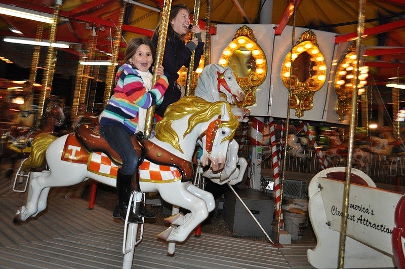Five-year-old Brook Strickland, front, rode the carousel with her cousin, Hope Kennedy.