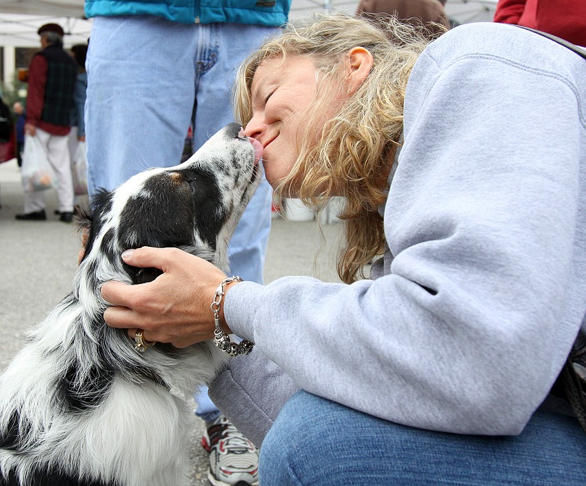 Toni Anderson gets some loving from Axel while shopping at the farmers market on Saturday, Jan. 22.