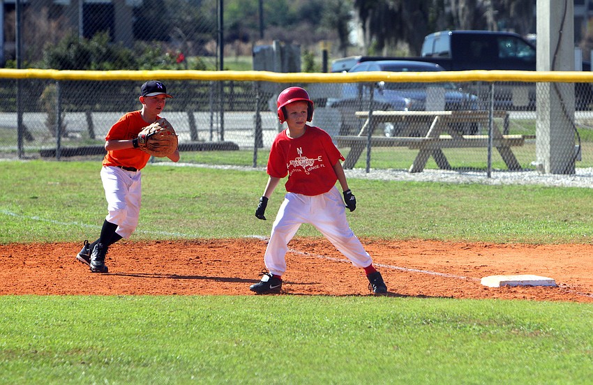 Everest Moll, 10, attempts to lead off base while 1st baseman Evan Gibbs, 9, watches closely on Saturday, Feb. 19 at Twin Lakes Park during Central Sarasota Little League Opening Day.