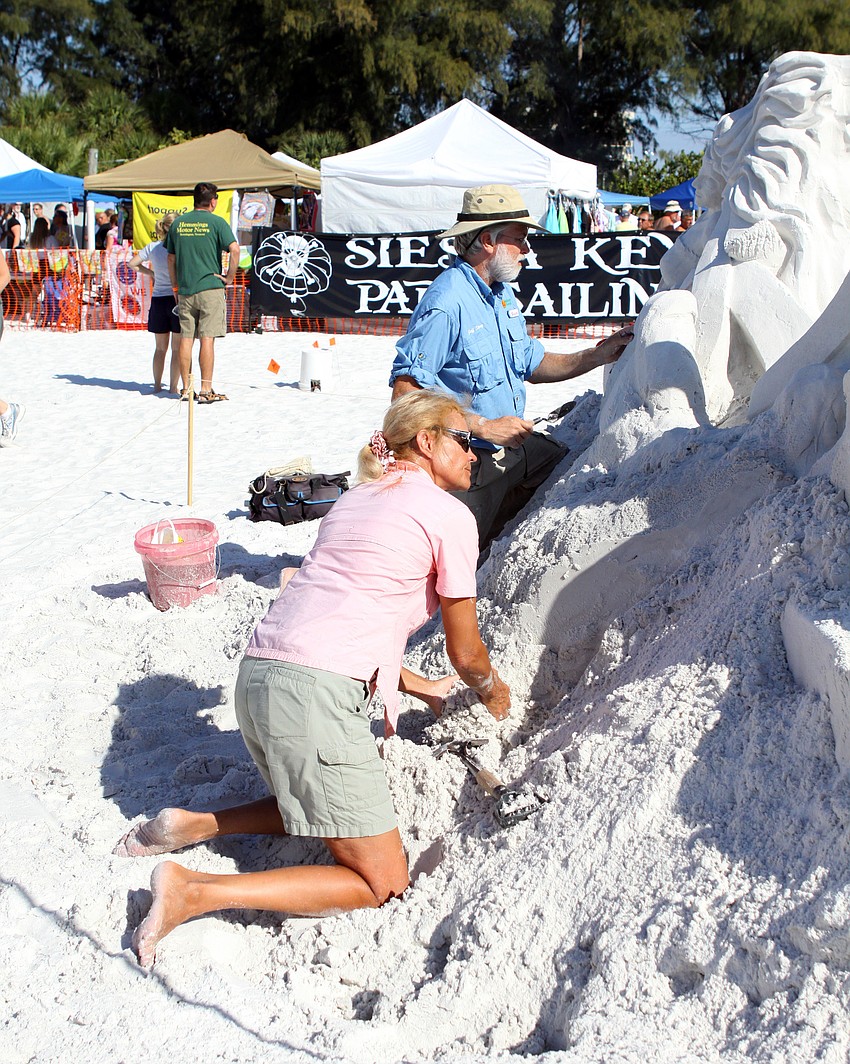 Jeff Strong and Katie Corning working on their sculpture Saturday afternoon.