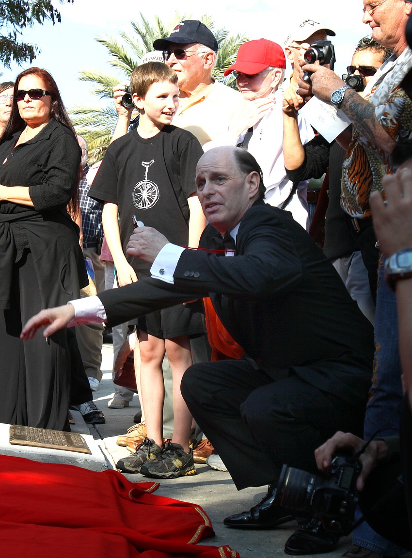 Chuck Sidlow gets ready to blow the whistle that signaled the newly inducted honorees and their sponsors to unveil their new plaques on the circle.