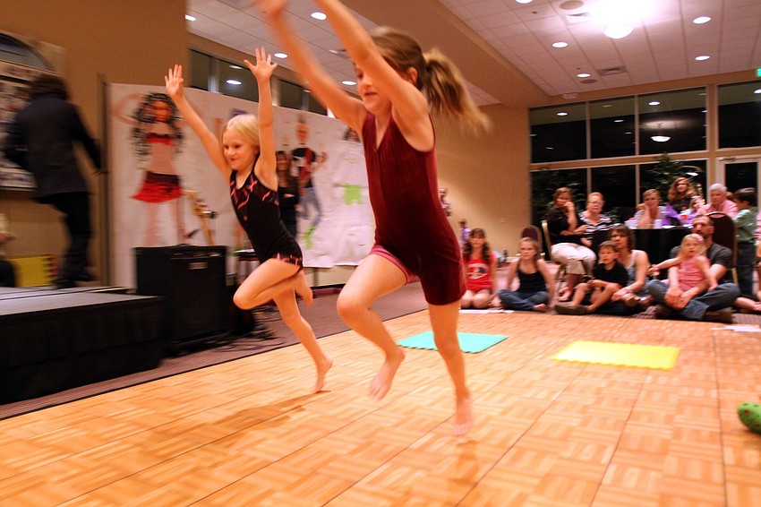 Claire, 6, and Elizabeth, 8, Karp Hauser perform some gymnastics moves on Feb. 26 at Temple Sinai's 2nd Annual 