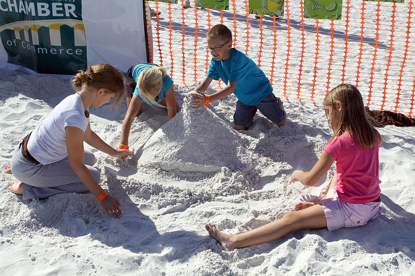 Kaia Cooper, Zoe Gavette, Maya Gavette and Jaxon Cooper work on their own sand sculpture, a volcano.