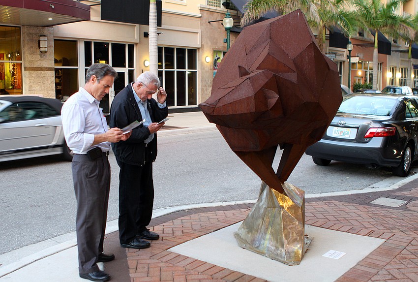 David Shapiro and Joel Seiden look at Beth Nybeckâ€™s sculpture, â€œPoint Defianceâ€, during the inaugural public art walking tour that was part of Thursday eveningâ€™s Intersections Kickoff Celebration.