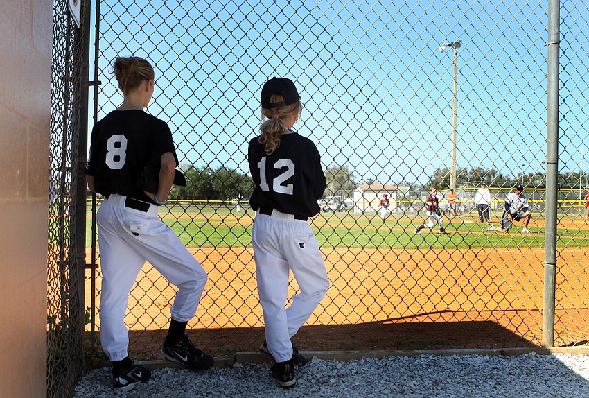 Hannah,11, and Sophia, 9, Hritz watch their brother's coach pitch team prior to playing their AAA game on Saturday, Feb. 19 at Twin Lakes Park during Central Sarasota Little League Opening Day.