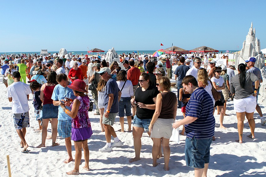People wander around viewing the sand sculptures at the Siesta Key Crystal Classic.