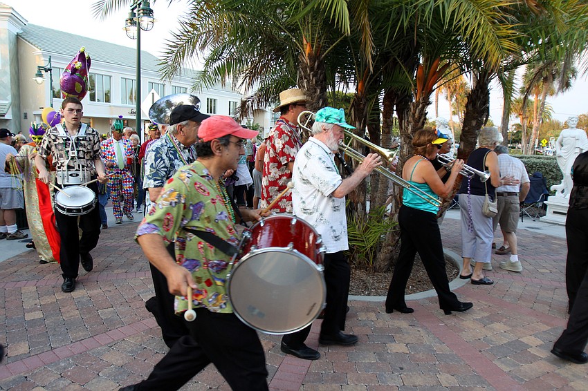 Joe Brunos Dixie Land Hotdogs lead the parade on the Circle on Tuesday, Mar. 8 during Masquerade â€” Mardi Gras St. Armands Style.