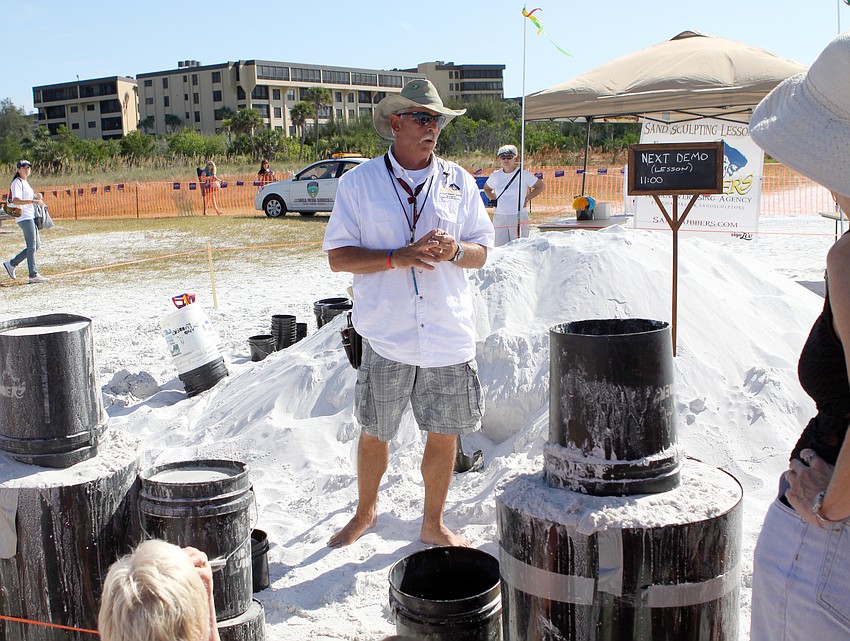 Bill Knight talks to a grouping of people who showed up for a sand sculpting demo during the Siesta Key Crystal Classic.