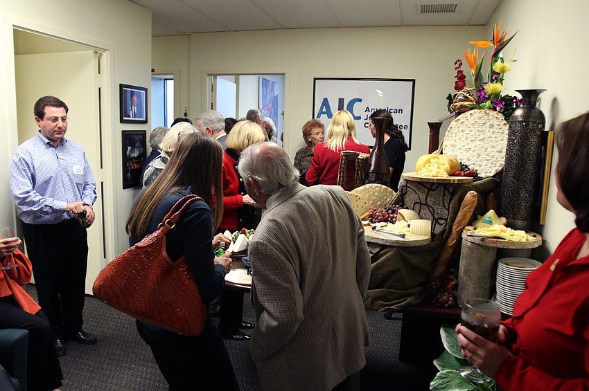 AJC members and friends enjoy cocktails and hors d'oeuvres during AJCâ€™s Grand Opening Cocktail Party Thursday evening. The event was put on to not only celebrate the New Year but to celebrate the new AJC office inside the Bank of America building.