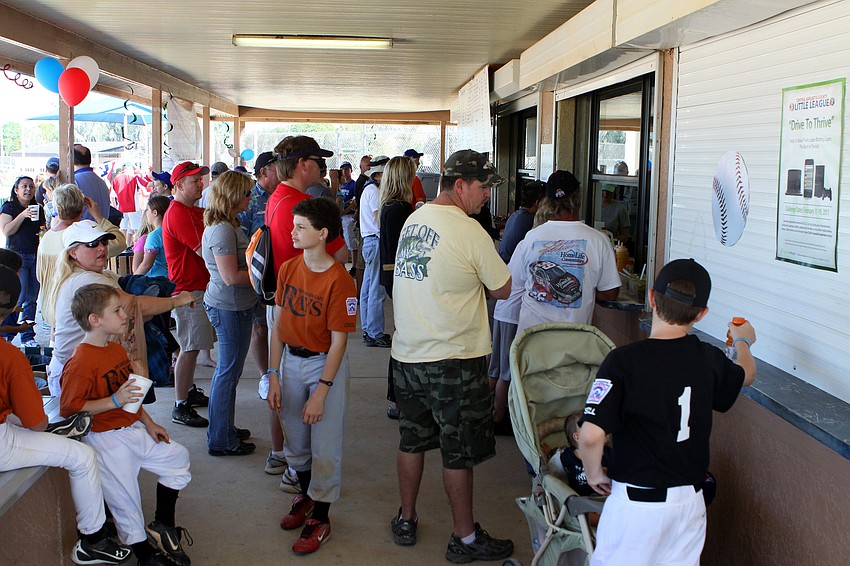 Crowds of people line up for food and drinks on Saturday, Feb. 19 at Twin Lakes Park during Central Sarasota Little League Opening Day.