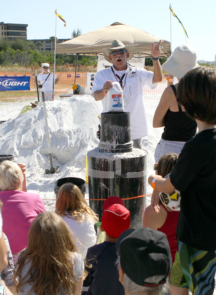 Bill Knight talks to a grouping of people who showed up for a sand sculpting demo during the Siesta Key Crystal Classic.