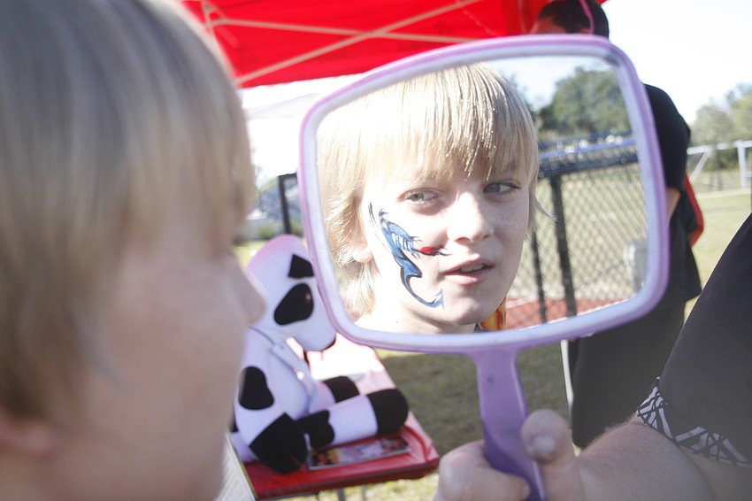 Tristen Borst, 12, loved his dragon face painting.