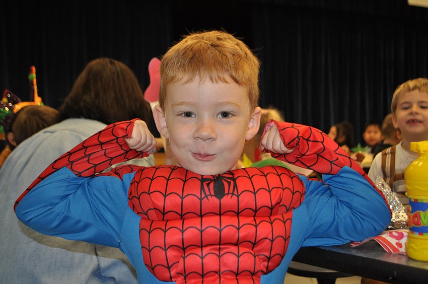 Gavin Montisano shows off his muscles in a superman costume.