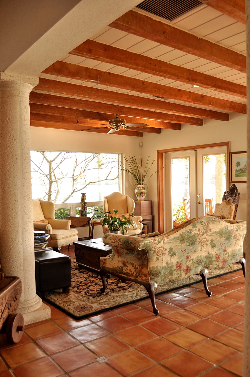 Treasures from Around the World: The ceiling beams, painted white by previous owners, were restored to their original wood color.