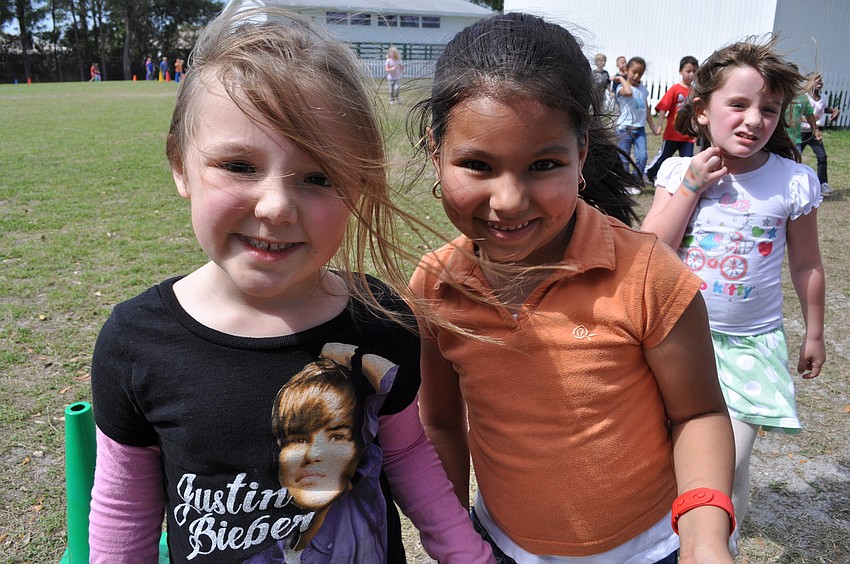 Shelby Henry, 5, and Nancy Jimenez, 6, walked together around the track.