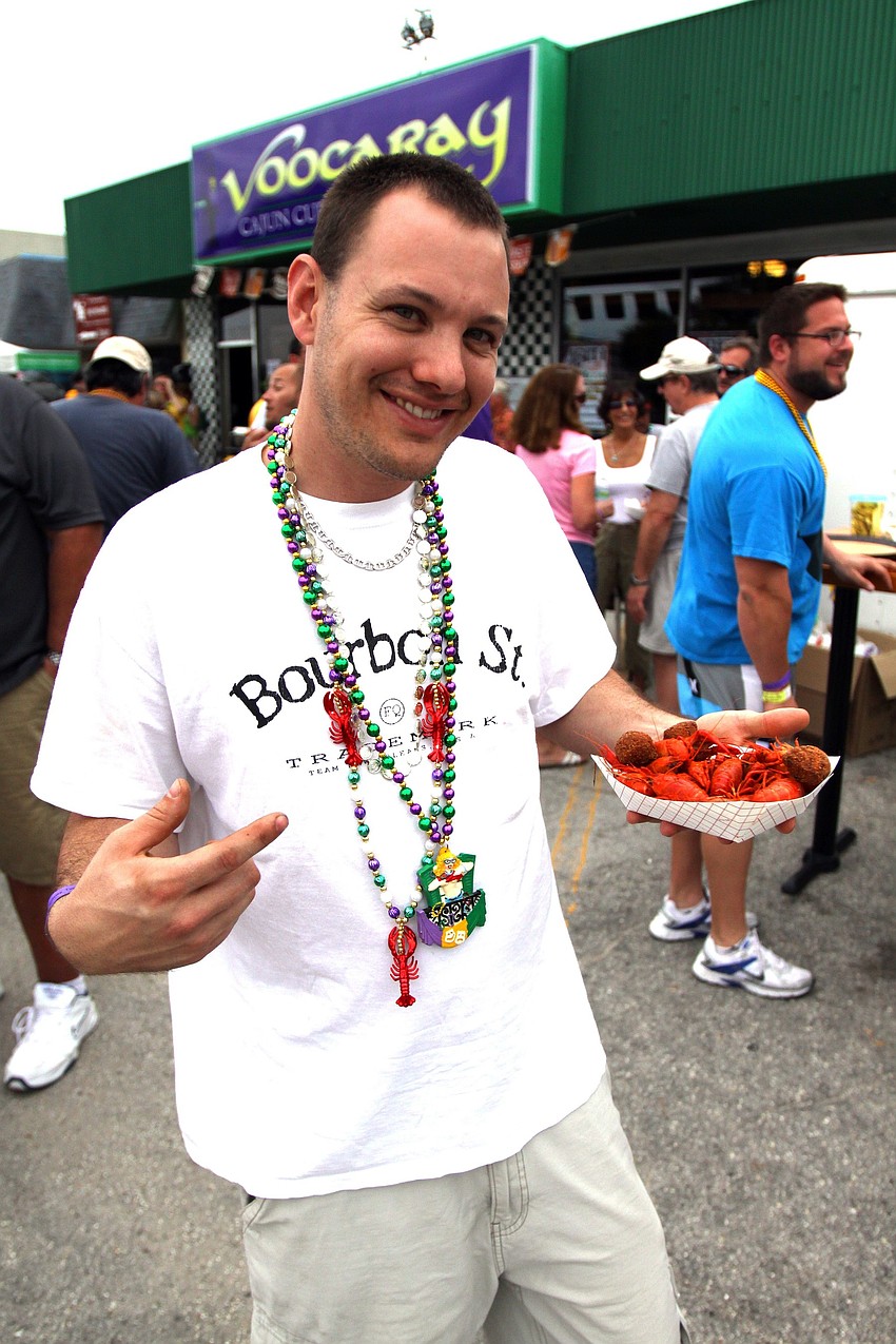 Chris Wilson shows off his crawfish and hush puppies on Sunday, March 6 for the 1st Annual Sarasota Mardi Gras that was held at Voocaray in Gulf Gate.
