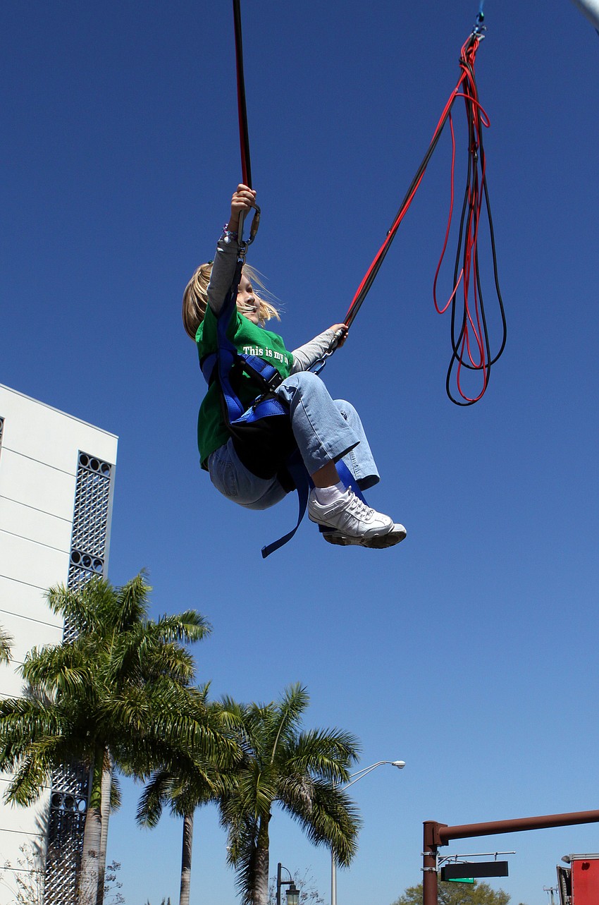 Sierra Smith, 7, has fun on the eXtreme jump! and even does a backflip on Saturday, March 12 at the Sham Rock Festival on Hillview.