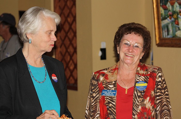 Linda Holland, right, shares a laugh with former Mayor Mollie Cardamone at her Election Night party at Broadway Bar.