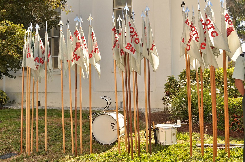 As they rounded the corner of the church, students dropped off their flagpoles and drums.