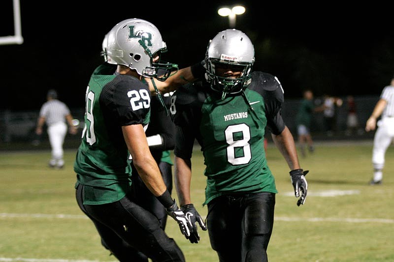 Harrison Skokos congratulates Taryn Laws after one of his three second-half touchdowns.