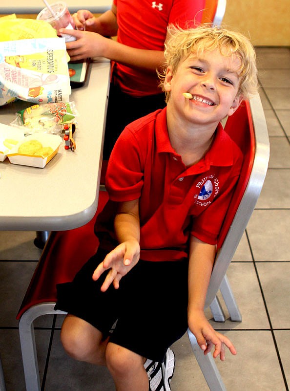 Ryon White, 5, cheeses it up for the camera.