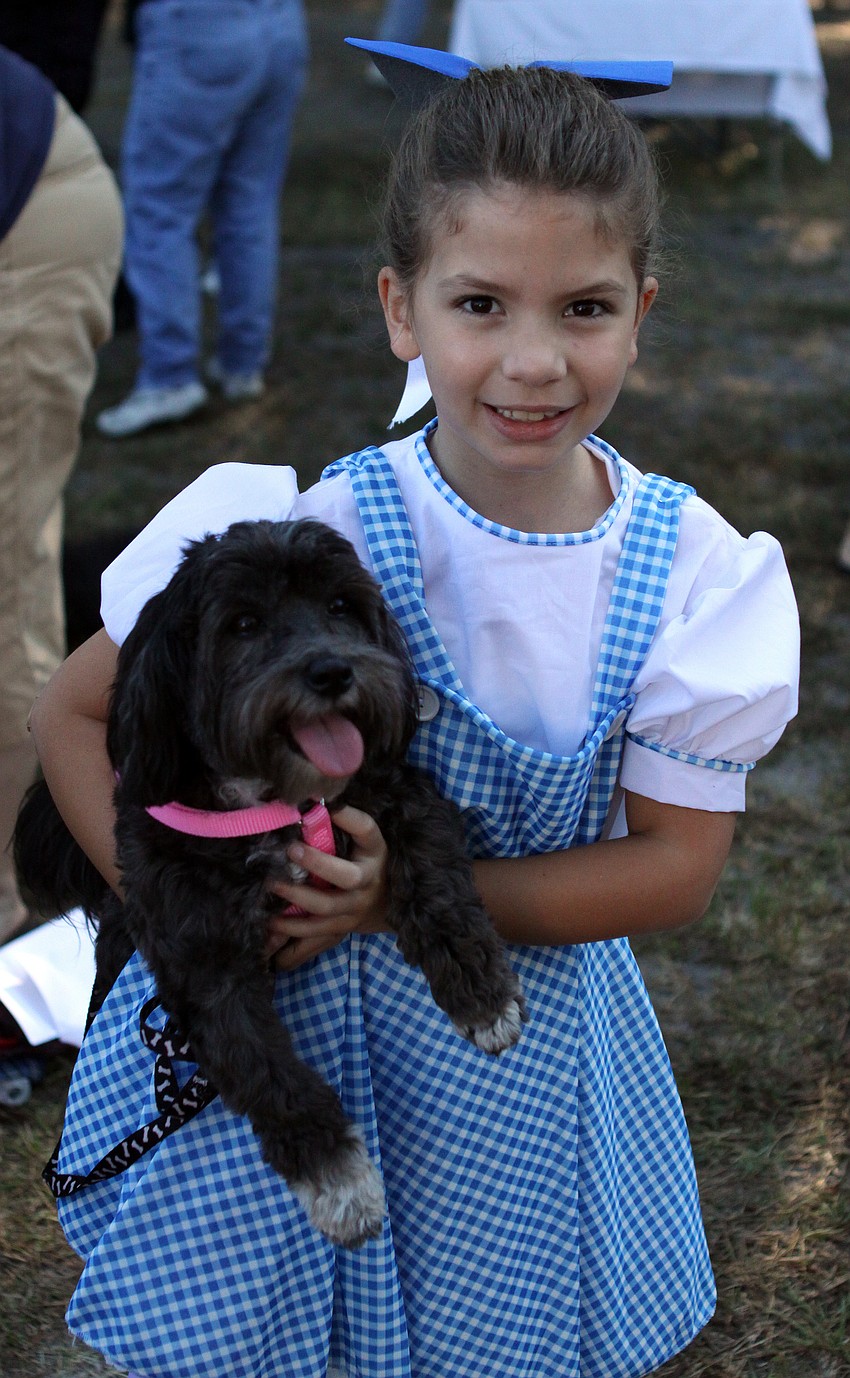 Pepper, 1, Havanese, plays Toto to Lauren Pellegrinoâ€™s, 7, Dorothy.