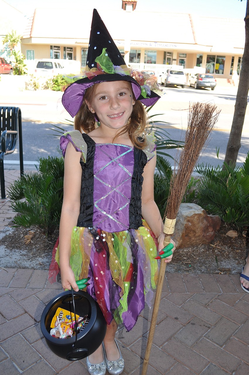 Marissa Govic, age 6, in a colorful witch costume.