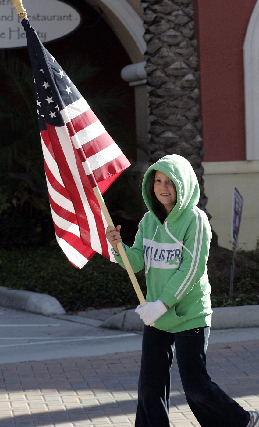 Eleven-year-old Rachel Mallett had the honor of caring the American flag.