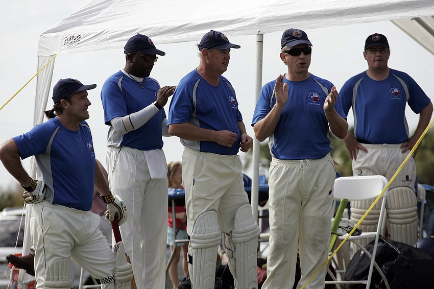 Members of the Memorial Cricket Club enjoy some down time before their game.