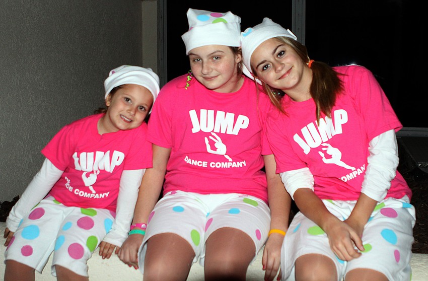 Casey Fults, Courtney Mynatt and Emma Slotabec hang out prior to performing in the parade.