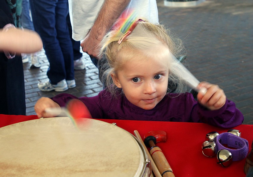 Morgan Hale beats a drum at the â€œinstrument petting zooâ€ that was set up for children to explore prior to the Sarasota Orchestraâ€™s concert at Mote.