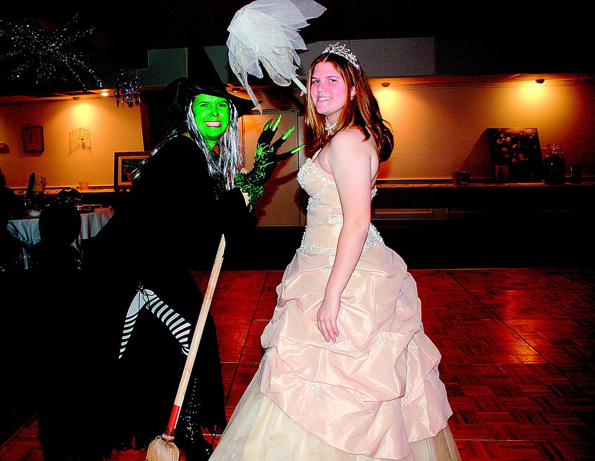 Mother-and-daughter Laura Zalkin and Alex Zalkin pose as good witch/bad witch on the dance floor at Temple Emanu-El's Purim Masquerade Ball in February.