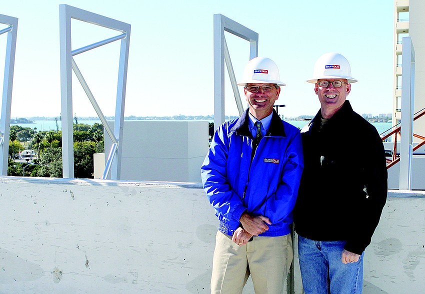 Team leaders Mike Beaumier, vice president of Suffolk Construction, and Jonathan Parks, senior principal of Jonathan Parks Architect, stand on the sixth level of the Palm Avenue parking garage in December.