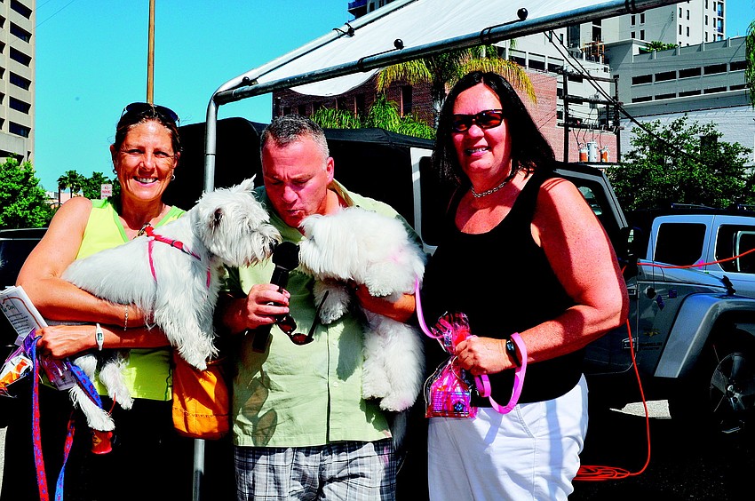 Denise Barbato, Allan Zuckerman and Ann Martin cuddle with Riley and Maddie in May at the Parade of Pups.
