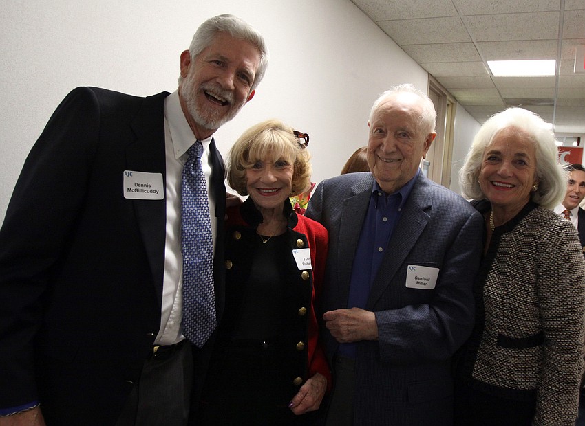 Dennis McGillicuddy, Flori Roberts, Sanford Miller and Graci McGillicuddy pose together Thursday evening at AJCâ€™s Grand Opening Cocktail Party at their new office in the Bank of America Building.