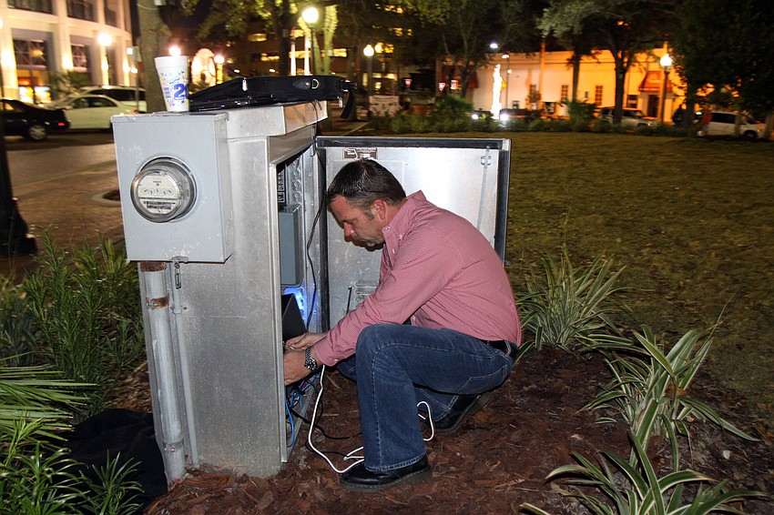 Matt Gregg works on fixing a few last minute things before the 7 p.m. inaugural display of Five Points Selby Parkâ€™s new tree light system. Gregg is from Synergy Lighting and was the man who designed and specified the lighting display.