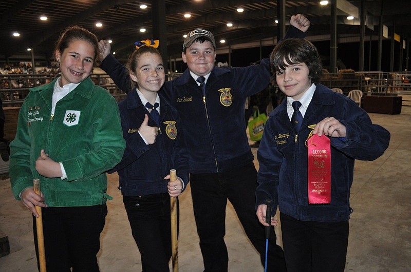 Nicholas Bartoszek, right, celebrated a 10th place finish in the swine show with friends Kylie Duquette of Myakka City Elementary School and fellow Nolan Middle School students Ashley Huddleston and Jerod Ballard.