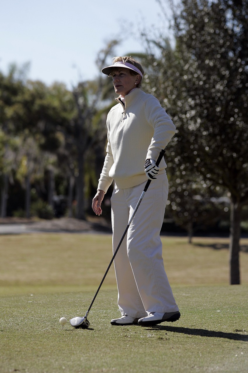 Carol Orr scopes out the hole before teeing off.